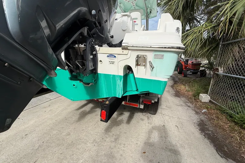 Slide: The Image of 2013 Sea Fox 286 Center Console boat on trailer, parked near palm trees. - 5