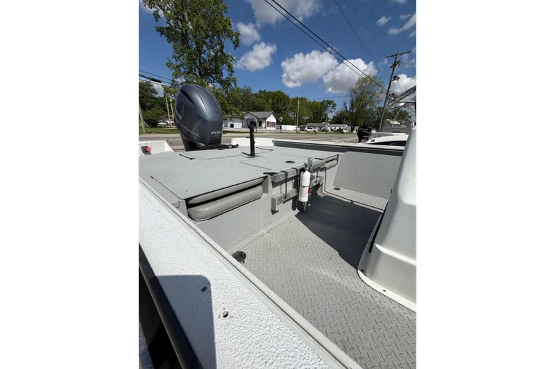 Slide: The Image of 2017 SeaArk BX220 boat deck with motor, under a clear blue sky. - 2