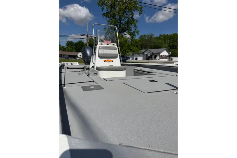 Slide: The Image of 2017 SeaArk BX220 boat with console, parked outdoors under a clear blue sky. - 4