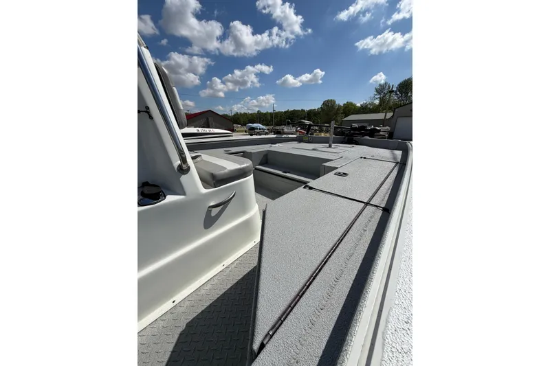 Slide: The Image of 2017 SeaArk BX220 boat deck under a clear blue sky with scattered clouds. - 5