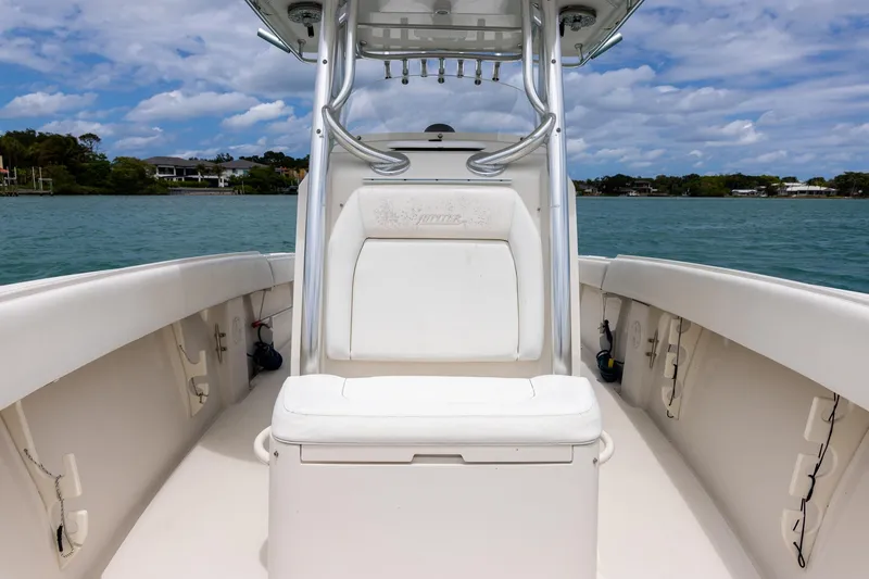 Slide: The Image of 2011 Jupiter 26 FS boat interior with seating, on calm water under a partly cloudy sky. - 11