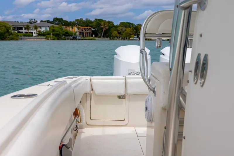 Slide: The Image of 2011 Jupiter 26 FS boat interior with Yamaha 250 engines on a calm waterway. - 12