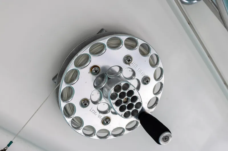 Slide: The Image of Close-up of a fishing reel on a 2011 Jupiter 26 FS boat. - 13