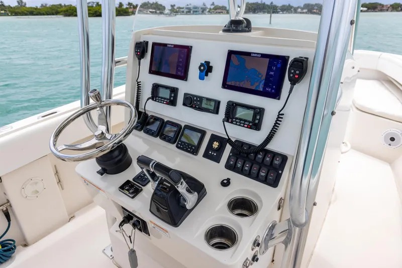 Slide: The Image of Control panel of a 2011 Jupiter 26 FS boat with navigation equipment. - 15