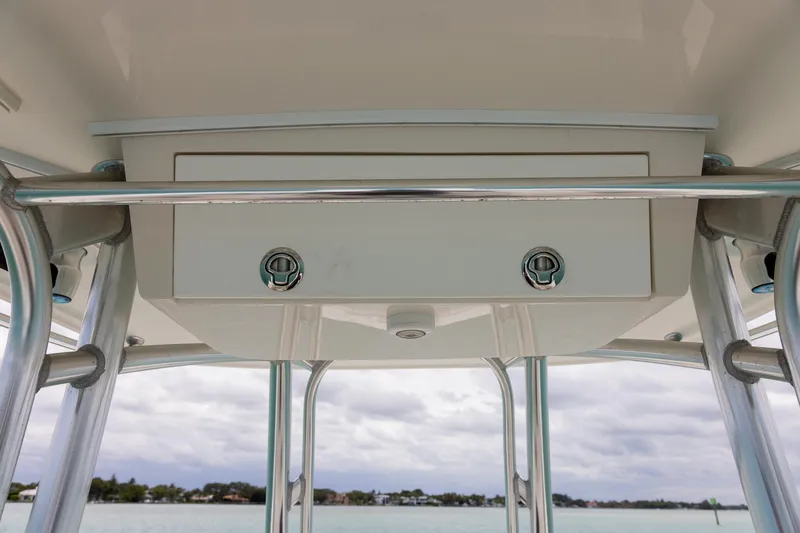 Slide: The Image of 2011 Jupiter 26 FS boat T-top storage compartment with ocean view background. - 16