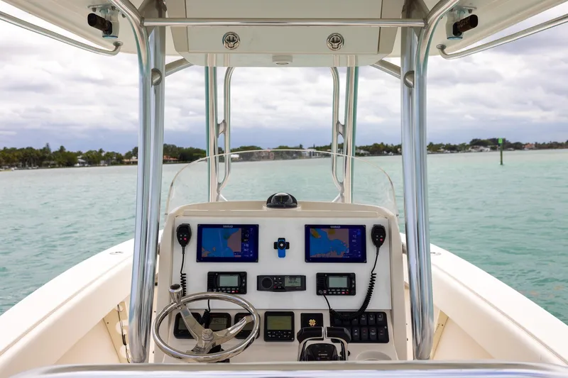 Slide: The Image of Helm of 2011 Jupiter 26 FS boat with navigation equipment on calm water. - 19