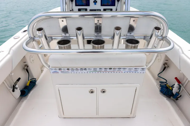 Slide: The Image of 2011 Jupiter 26 FS boat cockpit with rod holders and storage compartment. - 20