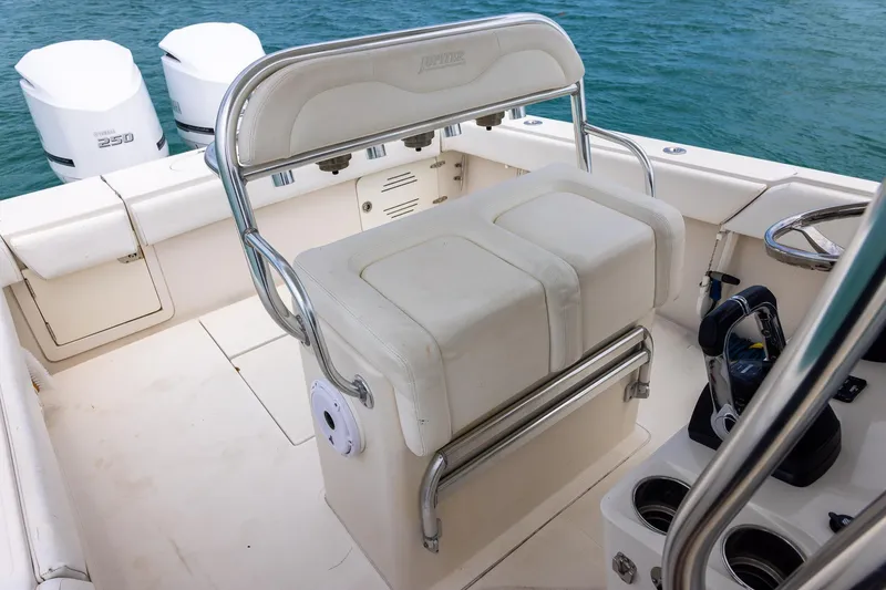 Slide: The Image of 2011 Jupiter 26 FS boat interior with seating and dual engines on water. - 22