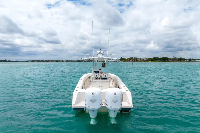 Slide: The Image of 2011 Jupiter 26 FS boat on turquoise water under cloudy sky. - 25