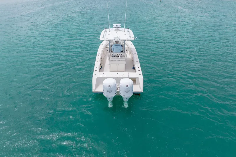 Slide: The Image of 2011 Jupiter 26 FS boat with dual engines on turquoise water. - 26