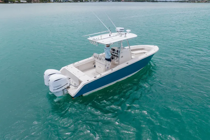 Slide: The Image of 2011 Jupiter 26 FS boat with dual Yamaha engines on turquoise water. - 27