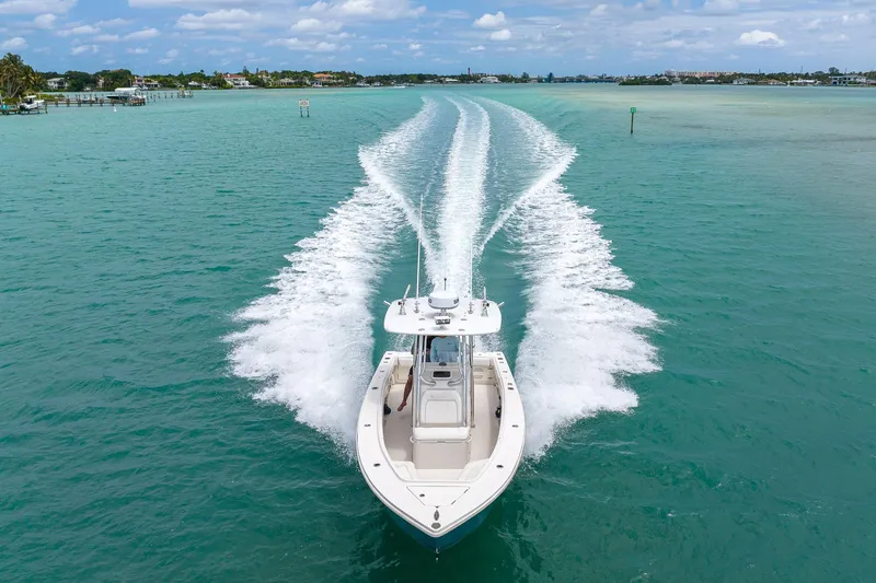 Slide: The Image of 2011 Jupiter 26 FS boat cruising on turquoise water, leaving a wake trail. - 32