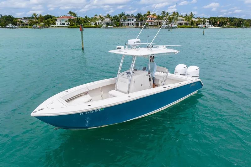 Slide: The Image of 2011 Jupiter 26 FS boat on turquoise water near luxury waterfront homes. - 4