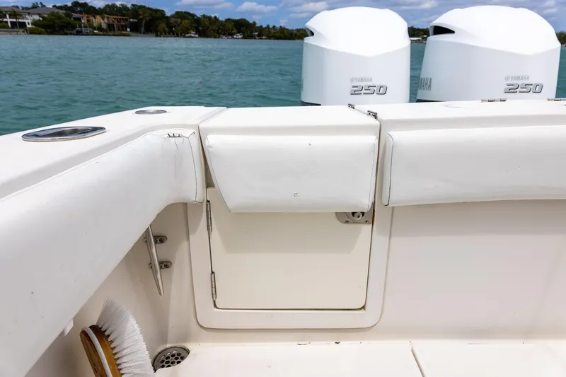 Slide: The Image of 2011 Jupiter 26 FS boat interior with Yamaha 250 engines on a calm lake. - 6