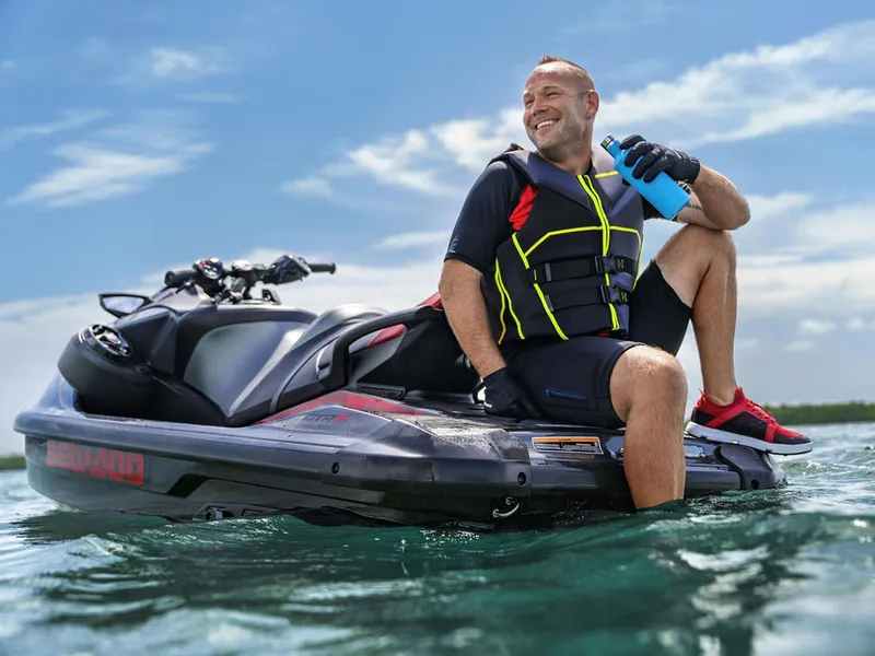 Slide: The Image of Man on Sea-Doo GTR-X 300 jet ski, 2024 model, enjoying sunny day. - 6