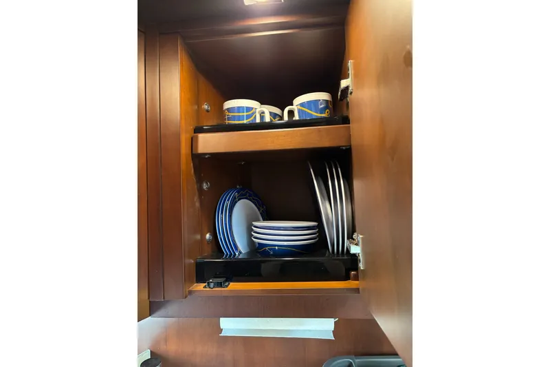 Slide: The Image of Wooden cabinet with blue and white dishes and mugs, Regal 42 Sport Coupe 2015. - 21