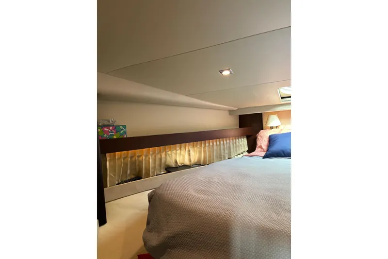 Slide: The Image of Luxurious interior cabin of 2015 Regal 42 Sport Coupe yacht with cozy bedding. - 23