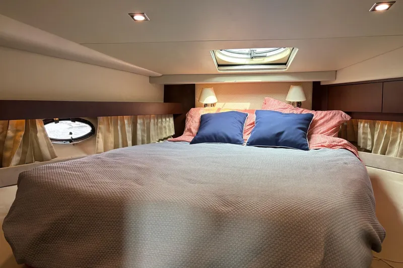 Slide: The Image of Luxurious cabin interior of 2015 Regal 42 Sport Coupe yacht with cozy bedding. - 24