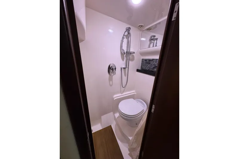 Slide: The Image of Compact bathroom in 2015 Regal 42 Sport Coupe yacht with shower and toilet. - 28