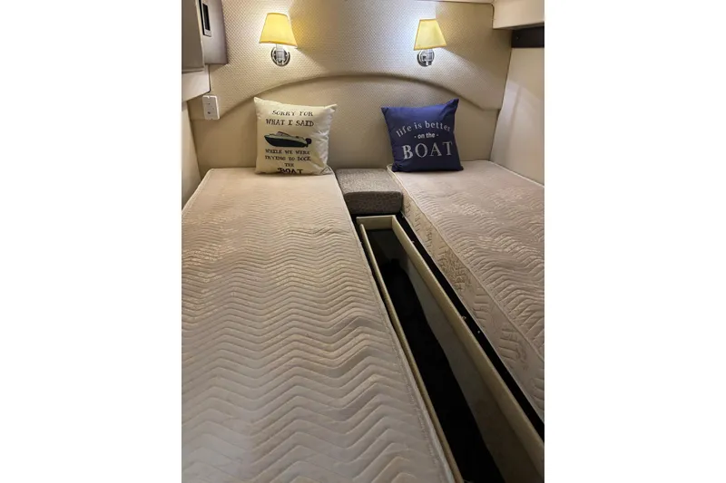 Slide: The Image of Interior cabin of 2015 Regal 42 Sport Coupe with twin beds and decorative pillows. - 30