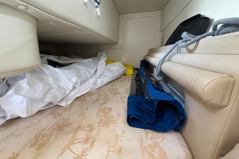 Slide: The Image of Interior cabin of a 2006 Rinker 250 Express Cruiser with stored items. - 16