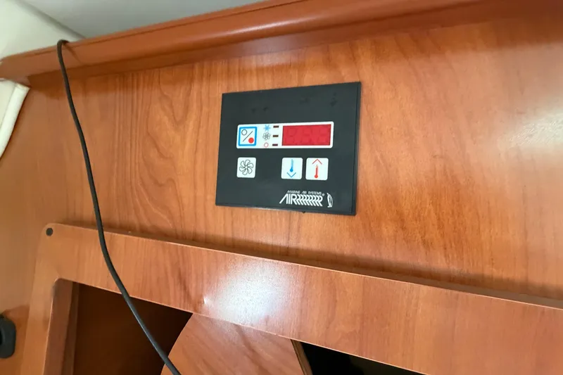 Slide: The Image of Control panel on 2006 Rinker 250 Express Cruiser's wooden interior. - 21
