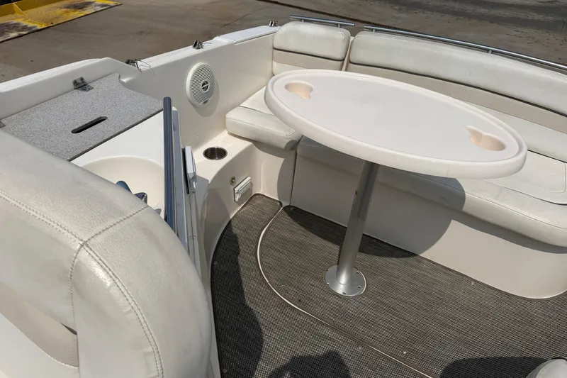 Slide: The Image of 2006 Rinker 250 Express Cruiser interior with seating and table setup. - 8