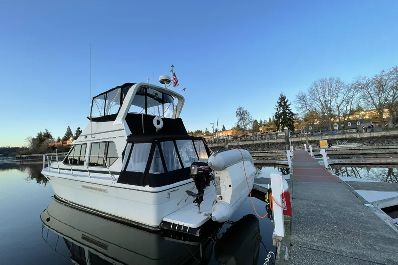 The Image of A Cooper Prowler Sedan boat docked at a marina, under a clear blue sky. - 0