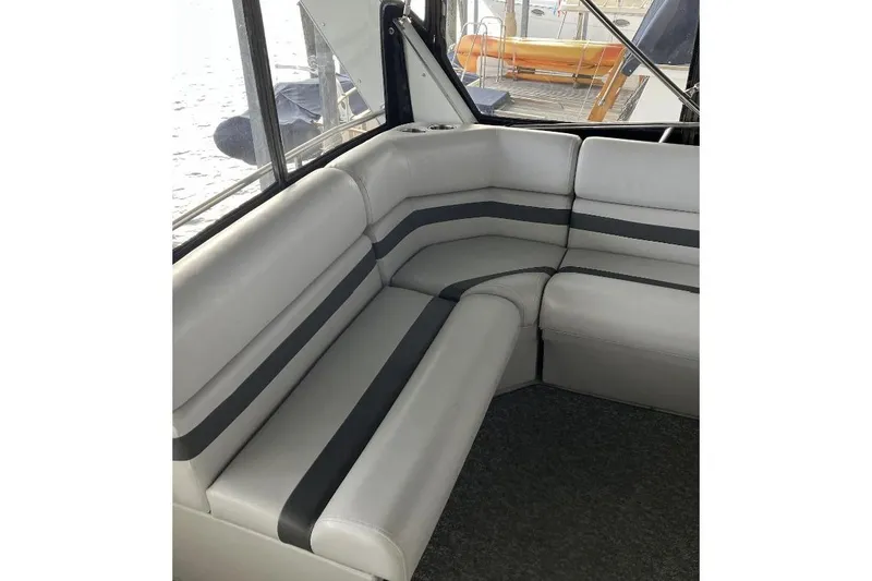 Slide: The Image of Gray and black boat seating with a view of the water outside. - 10