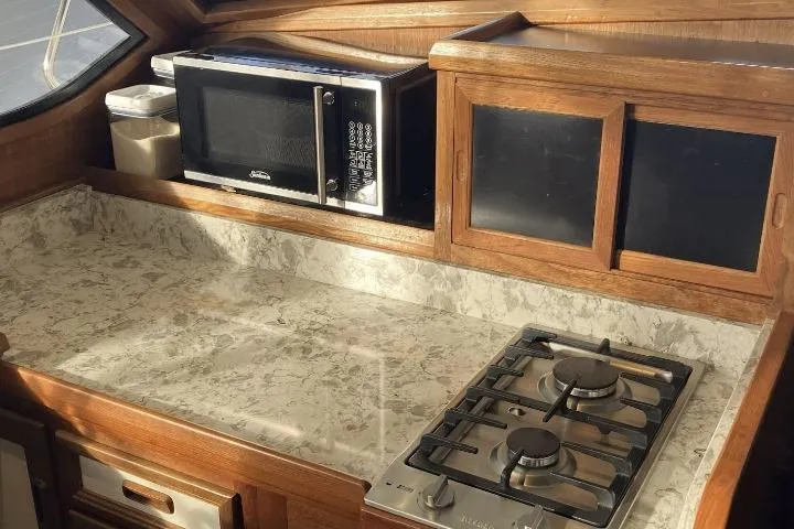 Slide: The Image of Compact kitchen with marble countertop, microwave, and gas stove in a Cooper Prowler Sedan, 1990. - 15