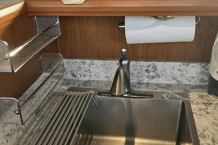 Slide: The Image of Stainless steel sink with marble countertop and wooden backsplash in a Cooper Prowler Sedan, 1990. - 16