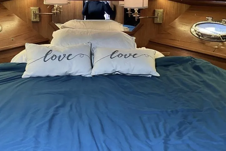 Slide: The Image of Cozy bedroom with blue bedding, "love" pillows, and wooden accents in a Cooper Prowler Sedan. - 20