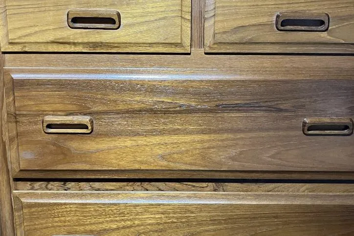Slide: The Image of Wooden dresser drawers with recessed handles, showcasing natural grain texture. - 21