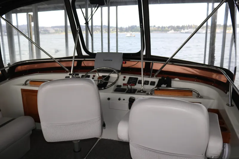 Slide: The Image of Interior view of a boat cockpit with steering wheel and navigation equipment. - 24