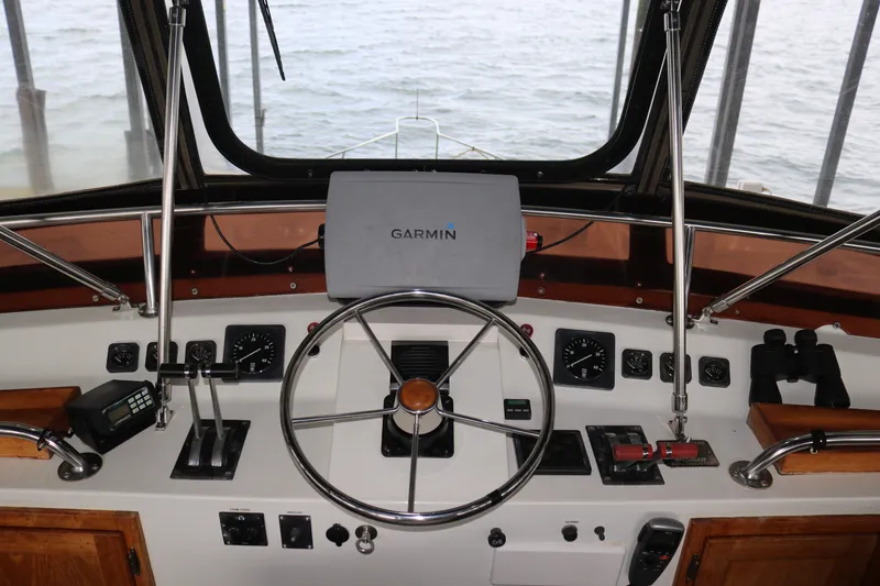 Slide: The Image of Boat cockpit with Garmin navigation, steering wheel, and control panel. - 26