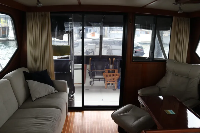 Slide: The Image of Interior of a 1990 Cooper Prowler Sedan boat with cozy seating and wooden accents. - 28