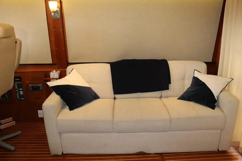 Slide: The Image of Luxurious interior of a 1990 Cooper Prowler Sedan with a beige sofa and navy accents. - 29