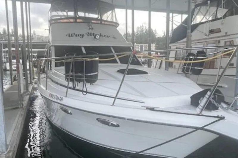 Slide: The Image of A boat docked in a marina, surrounded by other vessels. - 3