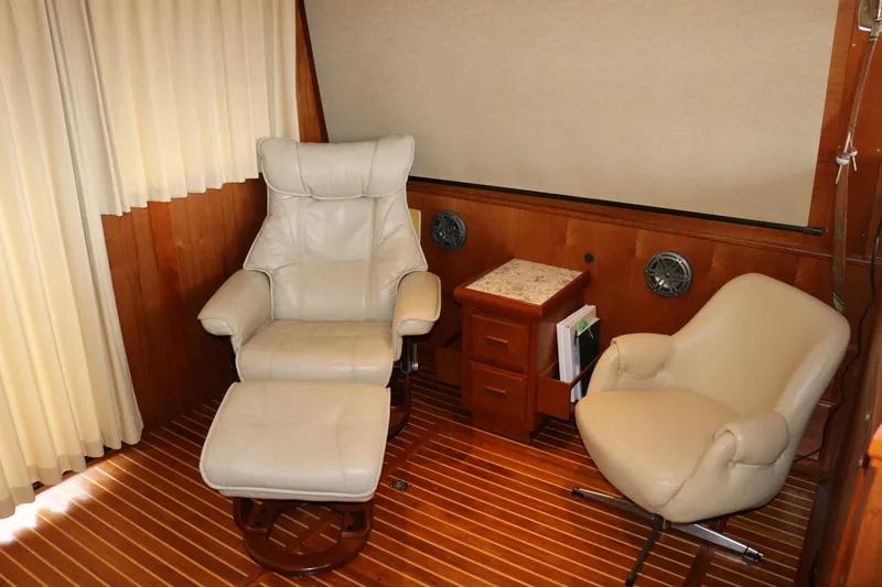 Slide: The Image of Luxurious interior of a 1990 Cooper Prowler Sedan with leather chairs and wooden accents. - 32