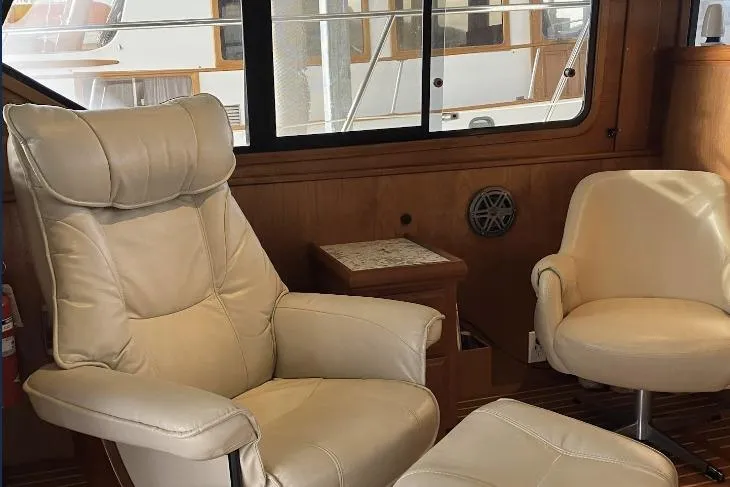 Slide: The Image of Luxurious boat interior with cream leather chairs and wooden accents, featuring a Cooper Prowler Sedan. - 33
