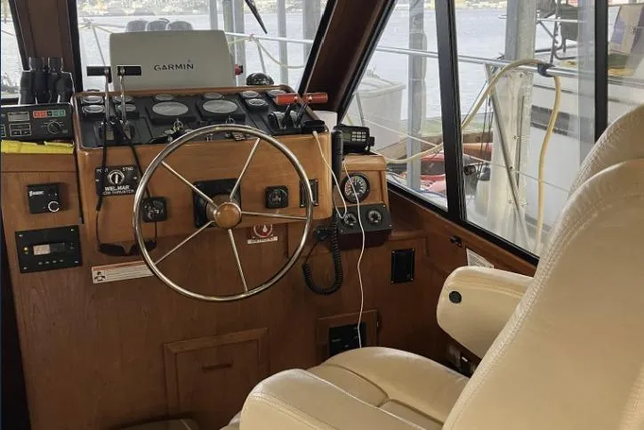 Slide: The Image of Boat cockpit with steering wheel, navigation equipment, and beige captain's chair. - 35