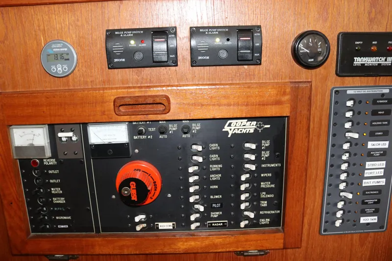 Slide: The Image of Control panel of a 1990 Cooper Prowler Sedan yacht with various switches and gauges. - 40