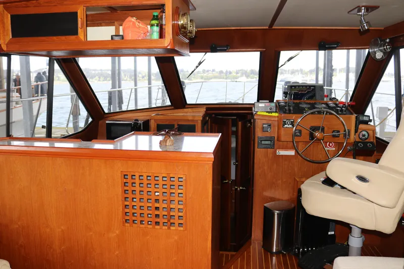 Slide: The Image of Interior of a 1990 Cooper Prowler Sedan boat with wooden helm and seating. - 42