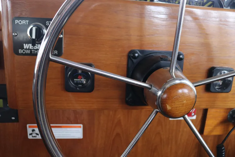 Slide: The Image of Wooden steering wheel on a 1990 Cooper Prowler Sedan boat dashboard. - 46