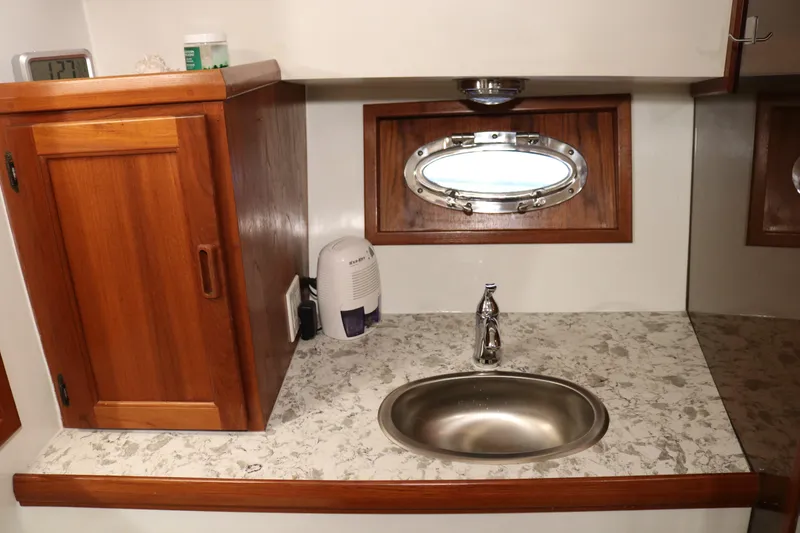 Slide: The Image of 1990 Cooper Prowler Sedan interior with wooden cabinetry and stainless steel sink. - 54