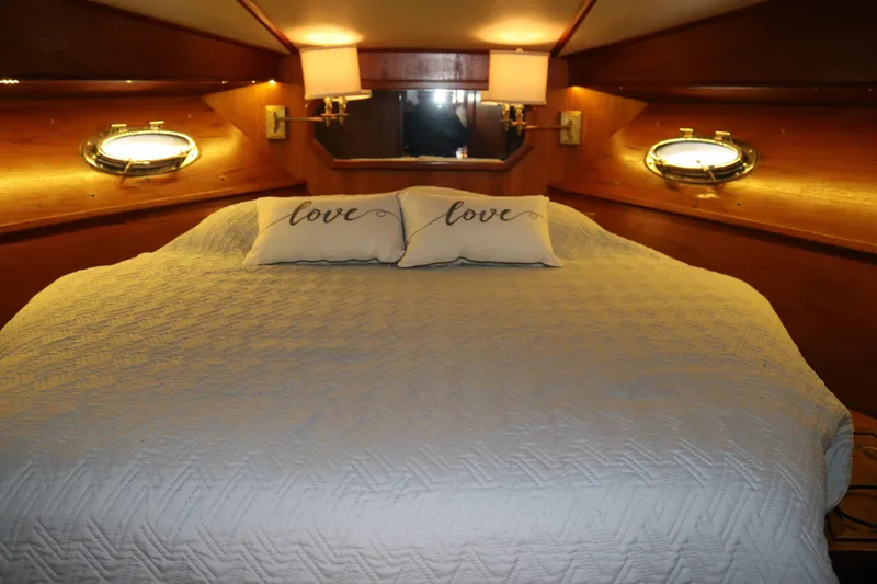 Slide: The Image of Luxurious boat cabin with cozy bed, "love" pillows, and warm lighting. - 61
