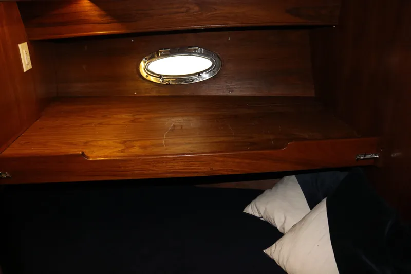 Slide: The Image of Wooden interior cabin with porthole and bedding, Cooper Prowler Sedan 1990. - 63
