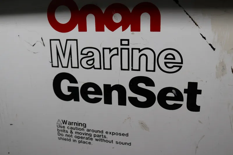 Slide: The Image of Onan Marine GenSet warning label with safety instructions on a white background. - 74