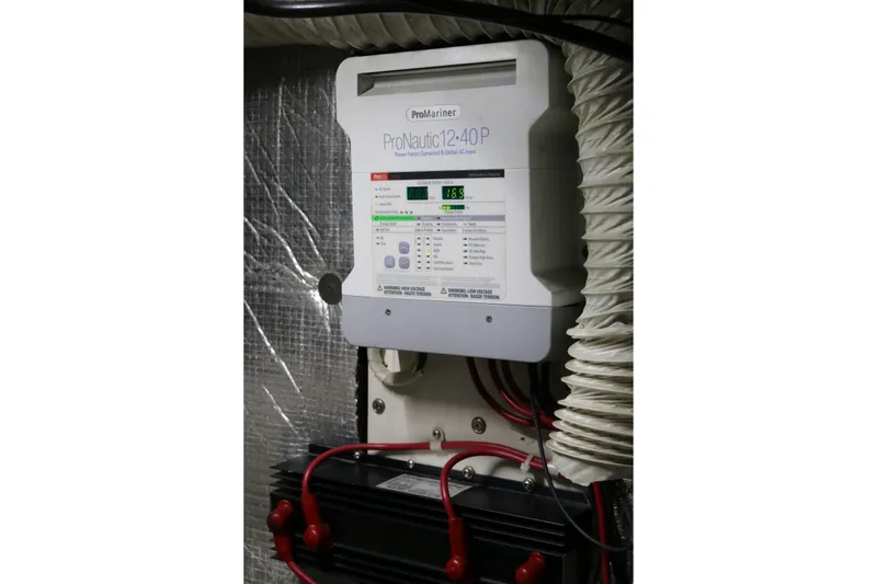 Slide: The Image of ```json { "alt_text": "ProNautic 1240P battery charger installed in a Cooper Prowler Sedan, 1990 model." } ``` - 75