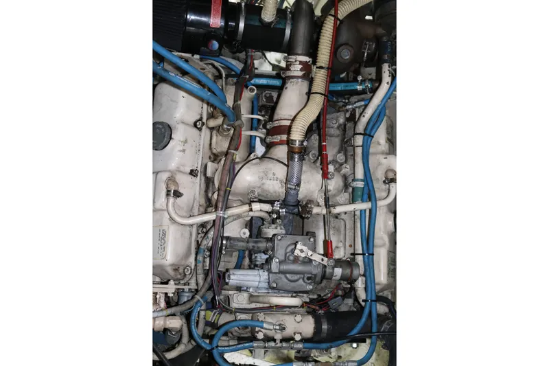 Slide: The Image of Engine of a 1990 Cooper Prowler Sedan with visible hoses and components. - 76